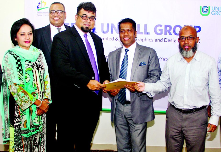 Nazeem A Choudhury, Head of Consumer Banking of Eastern Bank Limited (EBL) and Abu Syed Mohammad Tarique, Chief Executive Officer of Unifill Group are seen exchanging documents after signing a Payroll Banking Agreement in the city recently. Senior officia