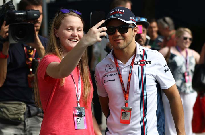 Williams driver Felipe Massa of Brazil takes a photo with a fan as he arrives at the Singapore Formula One Grand Prix on the Marina Bay City Circuit Singapore on Friday.