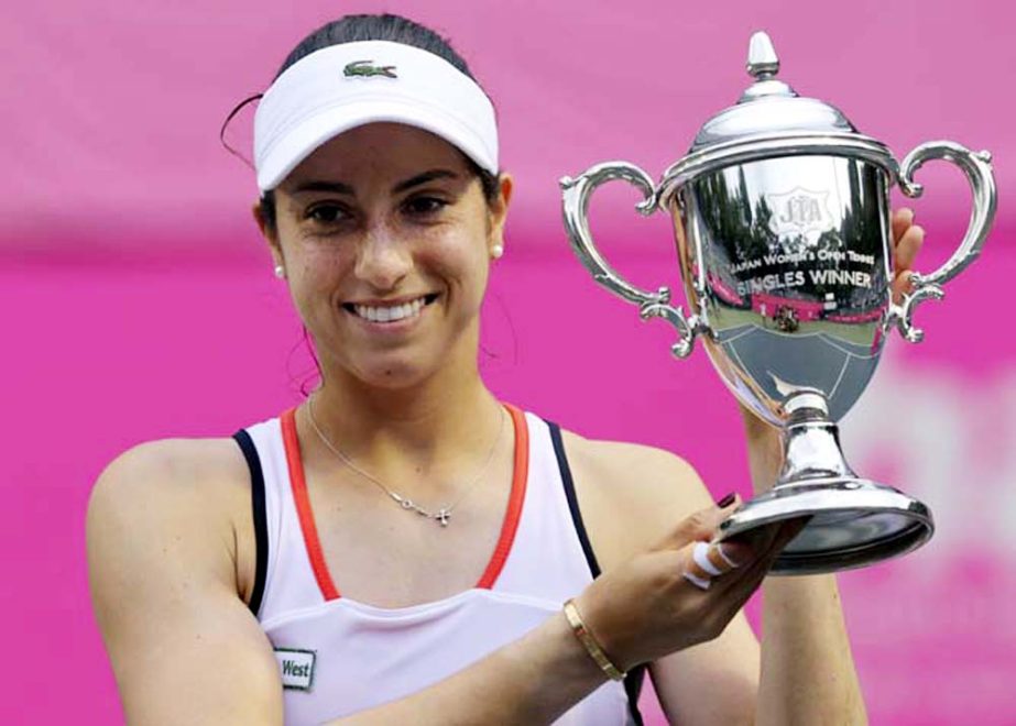 Christina McHale of the United States smiles with a trophy during the award ceremony of the Japan Women's Open tennis in Tokyo on Sunday. McHale rallied to beat Katerina Siniakova of the Czech Republic 3-6, 6-4, 6-4.