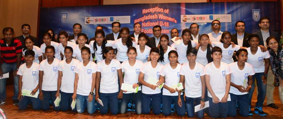 Players of Bangladesh Under-16 Women's Football team with the officials pose for photo at Pan Pacific Sonargaon Hotel on Monday.