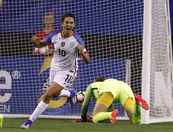 USA's Carli lloyd (10) celebrates after beating Netherlands goal keeper Sari van Veenendaal for a goal in the first half of an exhibition soccer match in Atlanta on Sunday.