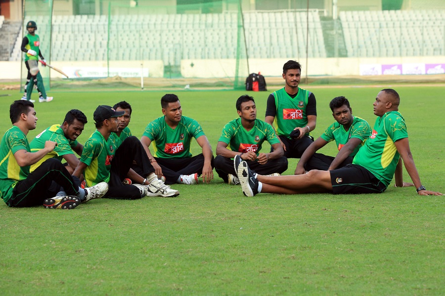 A group of pace bowlers keenly listen as Courtney Walsh addresses them during a training session at the Mirpur Sher-e-Bangla National Cricket Stadium on Tuesday.