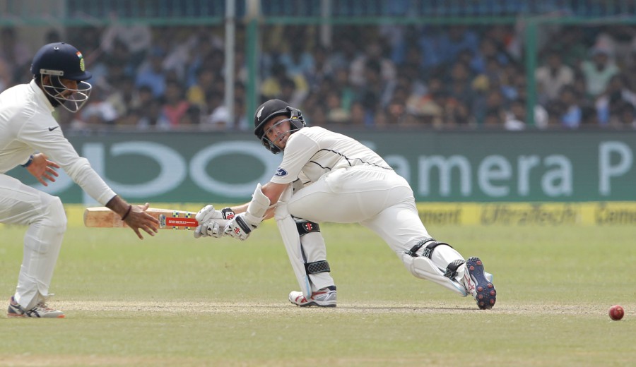 Kane Williamson executes the paddle sweep on the 2nd day of the 1st Test between India and New Zealand at Kanpur on Friday.