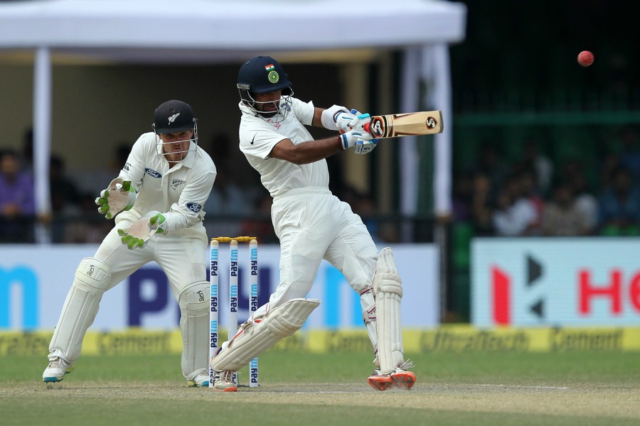 Cheteshwar Pujara lays into a short ball on the 3rd day of 1st Test between India and New Zealand at Kanpur on Saturday.