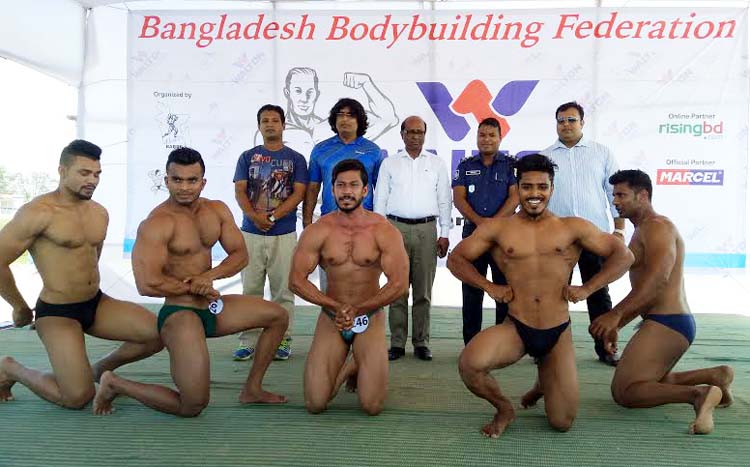 The bodybuilders perform during the Walton 2nd Beach Bodybuilding Tournament at the Laboni Point in Cox's Bazar Sea Beach on Saturday.