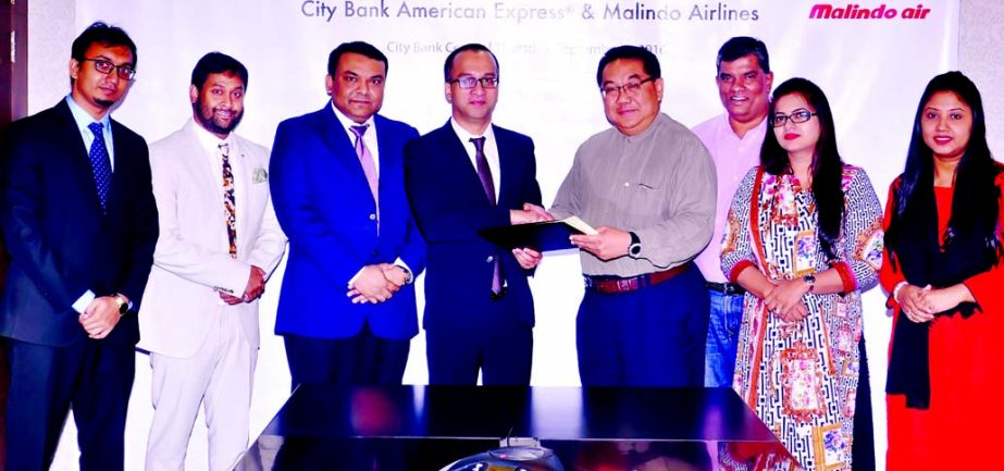 Mashrur Arefin, AMD of City Bank Ltd and Philip Phang, Managing Director of Malindo Air BD, exchanging documents after signed an e-commerce agreement. Under this arrangement Malindo Air will use City Bank's E-commerce Internet Payment Gateway to accept o
