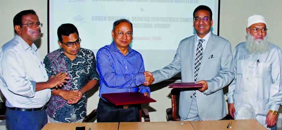 Mohammed Abu Sadek, Director of Housing and Building Research Institute and Mostofa Kamal Mohiuddin, Chairman of BDG-Magura Group, Shaking hands after signing an agreement in the city recently. Under the deal environment friendly green brick will be manuf