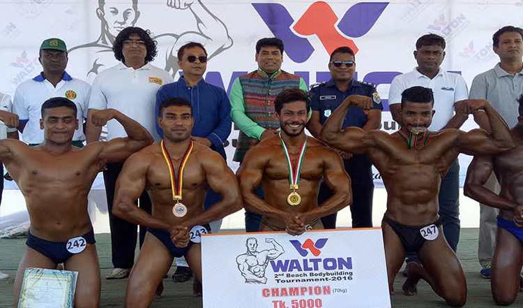 The winners of the Walton 2nd Beach Bodybuilding Tournament with the official of Bangladesh Bodybuilding Federation and the officials of Cox's Bazar District pose for a photo at the Laboni Point of Cox's Bazar Sea Beach on Sunday.