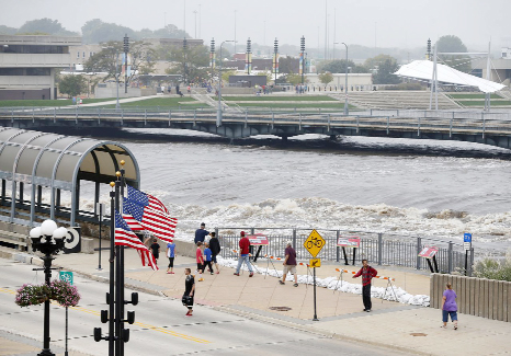 People view the flooding on the Cedar River in downtown Waterloo, Iowa on Saturday.