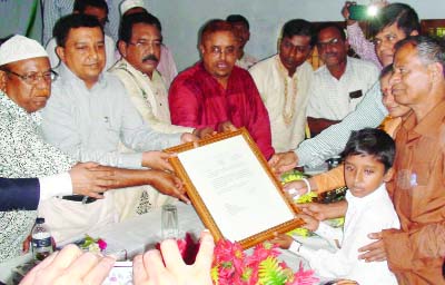 PATUAKHALI: Awami League leaders with high officials in Patuakhali district administration handing over Prime Minister Sheikh Hasina's letter to school student Shishendro and his family at a ceremony recently.