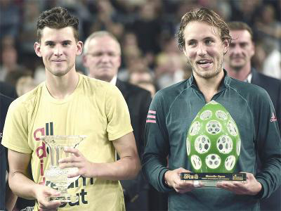Lucas Pouille (right) holds his trophy beating top-seeded Dominic Thiem of Austria in the Moselle Open final on Sunday.