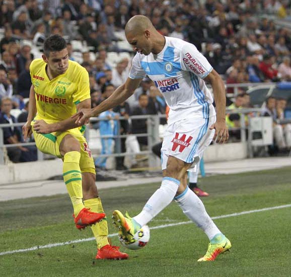 Nantes' forward Mariusz Stepinski (left) challenges Marseille's defender Matheus Doria Macedo for the ball during the League One soccer match between Marseille and Nantes in Marseille, southern France on Sunday.