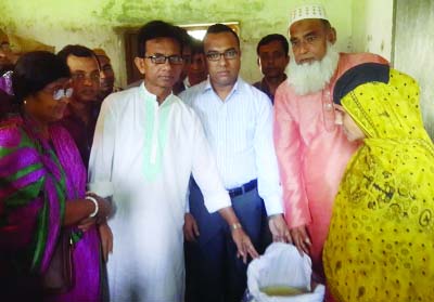 TRISHAL(Mymensingh): Jainal Abedin, Chairman, Trishal Upazila Parishad distributing relief goods among the poor people of the Upazila recently.