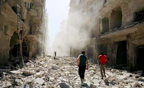 Men inspect the damage after an airstrike on the rebel held al-Qaterji neighbourhood of Aleppo.