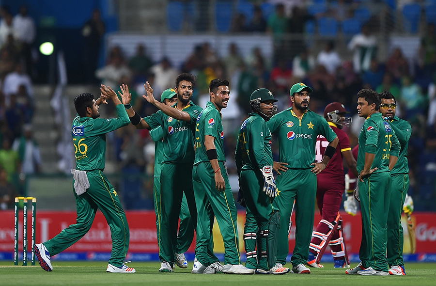 The Pakistan players gather around Imad Wasim to celebrate Dwayne Bravo's wicket during their 3rd T20i against West Indies in Abu Dhabi on Tuesday.