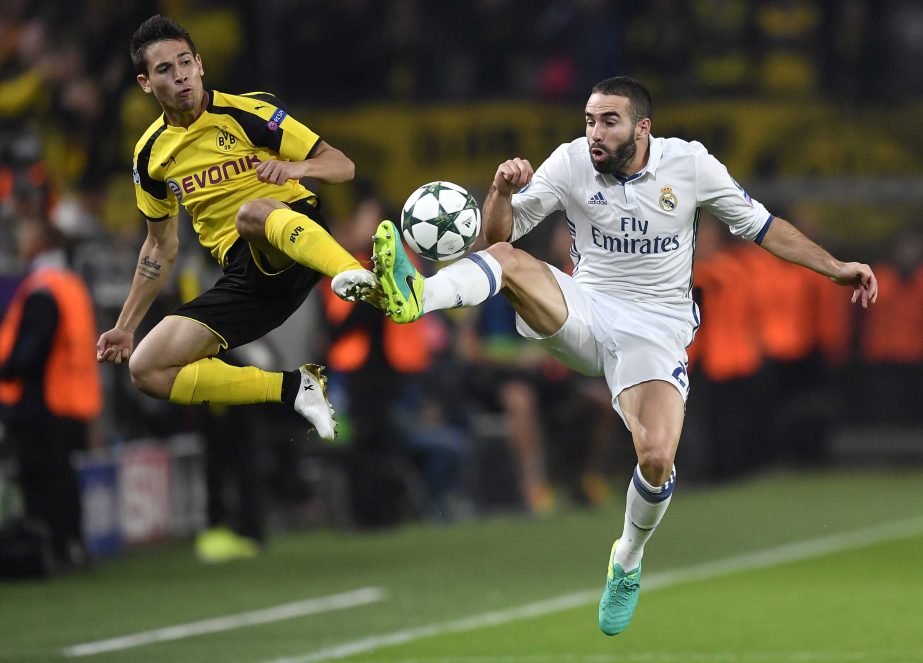 Dortmund's Raphael Guerreiro (left) and Real Madrid's Dani Carvajal challenge for the ball during the Champions League Group F soccer match between Borussia Dortmund and Real Madrid in Dortmund, Germany onTuesday.