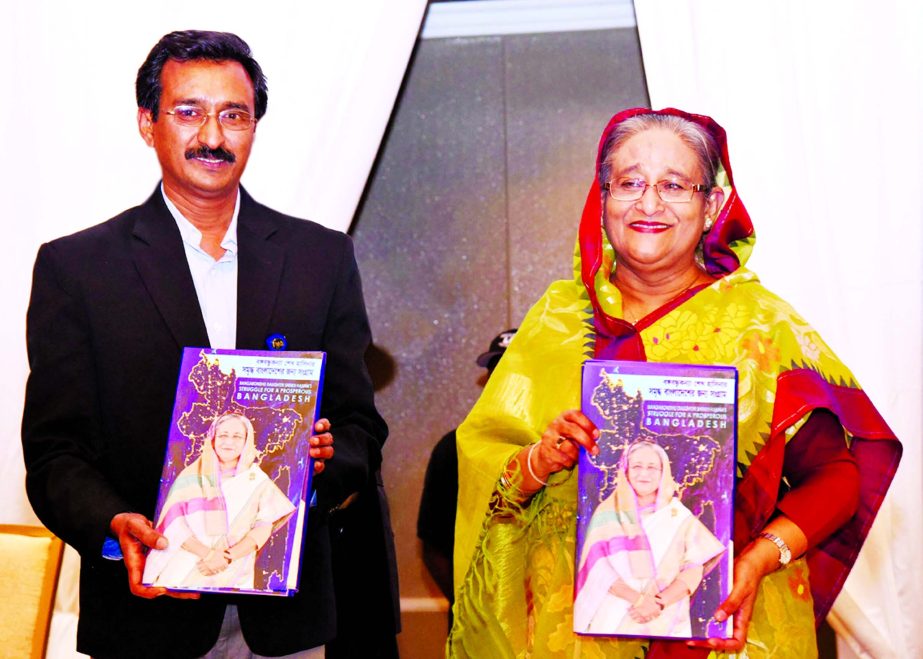 Owner of Joyeeta Prokashoni journalist Yasin Kabir Joy handed over a book titled ' Bangabandhu's daughter Sheikh Hasina's Struggle for the Prosperous Bangladesh' to Prime Minister Sheikh Hasina at its cover unwrapping ceremony at a hotel in Washington