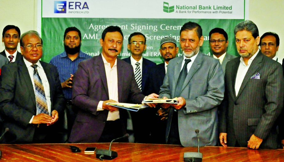 ASM Bulbul, Deputy Managing Director of National Bank Ltd and Md. Serajul Islam, CEO of ERA Info-tech Ltd are seen exchanging document after signing an agreement on `Anti-Money Laundering and Sanction Screening Software' in the city recently. Choudhury M