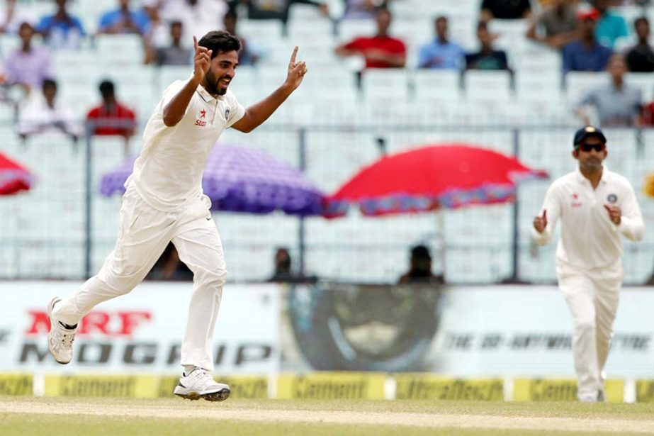 Bhuvneshwar Kumar of India celebrates the wicket of Martin Guptill of New Zealand during day 2 of the second Test match between India and New Zealand held at the Eden Gardens in Kolkata on Saturday.