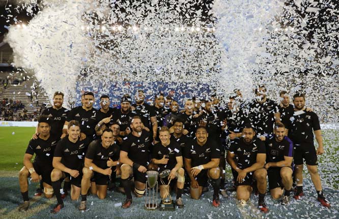 New Zealand's All Blacks team celebrate with the trophy after winning the rugby championship in Buenos Aires, Argentina on Saturday.