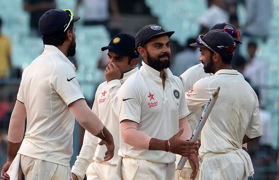 India's captain Virat Kohli (C) celebrates with teammates after victory on the fourth day of the second Test match against New Zealand at the Eden Gardens Cricket Stadium in Kolkata on Monday.