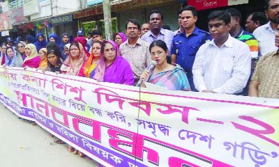 RAJBARI: Zinat Ara, DC, Rajbari speaking at a human chain in Rajbari on the occasion of the National Girl Child Day organised by Rajbari Women Directorate recently.