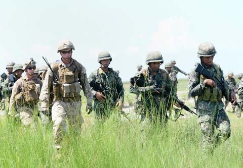 Philippine marines (in green) and their US counterparts (in light brown), seen after simulating an assault during their annual amphibious landing exercise in San Antonio