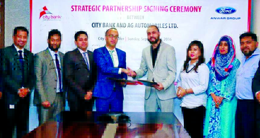 Mashrur Arefin, AMD and CCO of City Bank Ltd and Yousuf Aman, Director of Operations of AG Automobiles exchanging documents after signing an agreement on Tuesday in the city. High officials of both organizations were present in the signing ceremony.