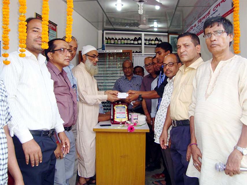 Principal Dr. Abdul Karim seen distributing free homeo medicines at the function of Bahir Signal Homeo Research Centre as chief guest in the Port City on Monday.