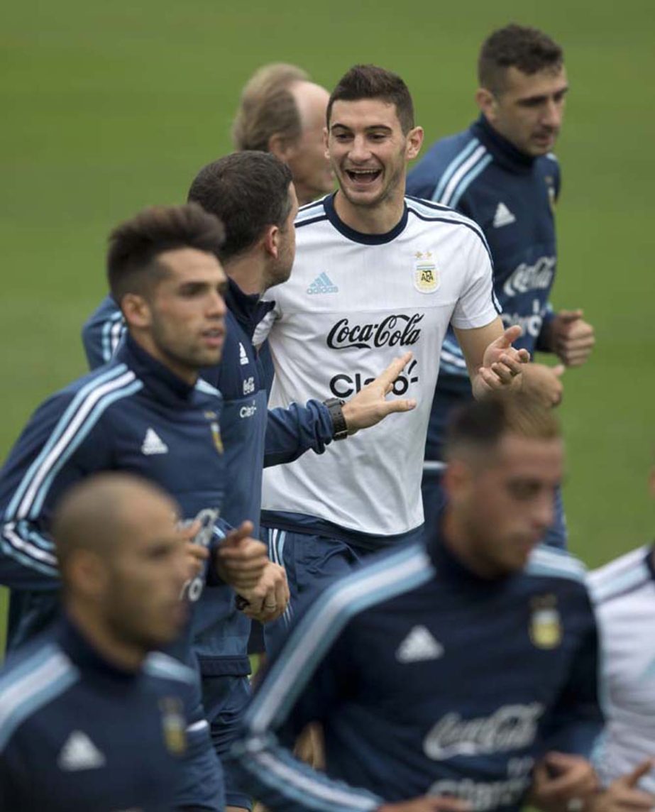 Argentina's Lucas Alario laughs while he runs with his teammates during a training session in Lima, Peru on Monday. Argentina will face Peru in a World Cup qualifying soccer game in Lima tomorrow (Thursday).