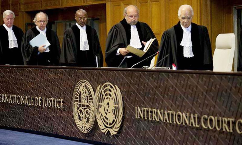 Judges, with Presiding Judge Ronny Abraham of France, second right, re-enter the World Court in The Hague, Netherlands on Wednesday to read the verdict in the case of the Marshall Island versus Pakistan.