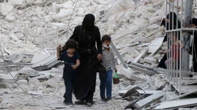 A Syrian family leaves the area following a reported airstrike on Friday in rebel-held east Aleppo.