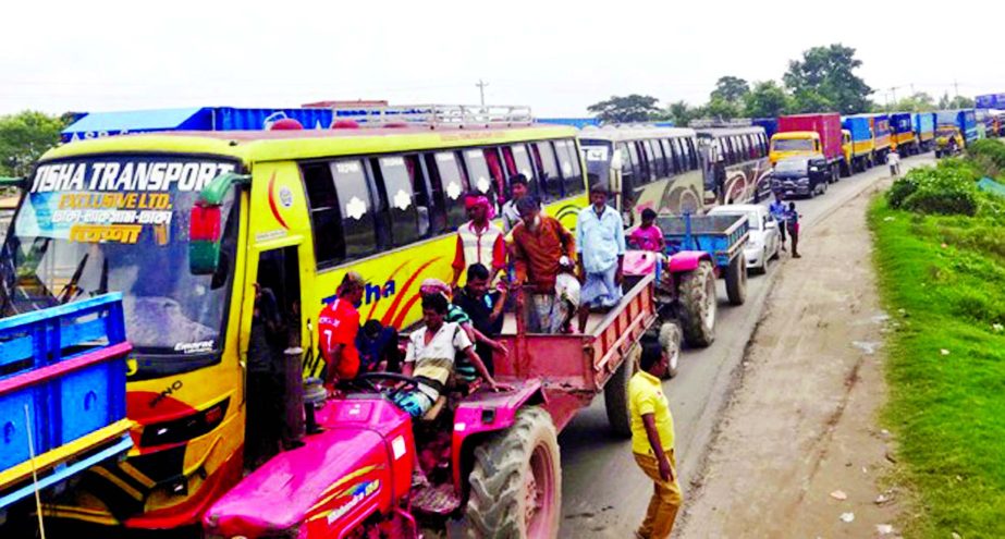 Around 45 km traffic gridlock on Dhaka-Chittagong Highway following goods laden Covered Van disordered on Meghna Bridge on Friday creating obstacles to movement of vehicles for several hours. This photo was taken from the Bridge area.