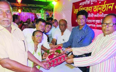 KISHOREGANJ: Poura Mayor Mahmud Parvez distributing clothes among the poor people at Kalibari premises as the Chief Guest organised by Zilla Puja Udjapon Parishad on Thursday. Adv Bijoy Sankar Roy chaired the programme and Adv Bhupendra Voumik Dolon, Tr