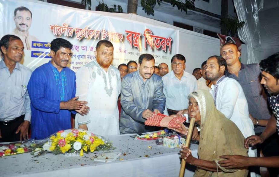 CCC Mayor A J M Nasir Uddin distributing clothes among the poor people of hindu community marking the Durga Puja yesterday.