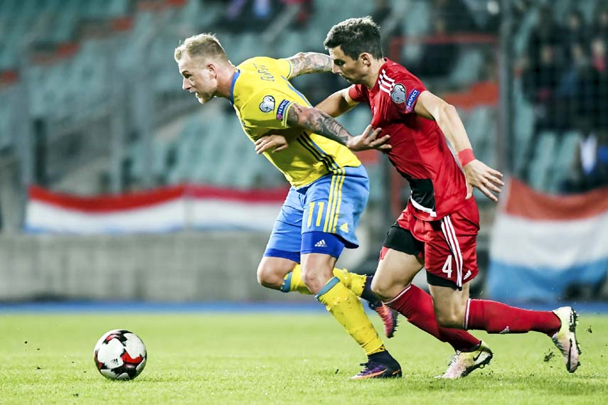 Luxembourg's Kevin Malget (right) challenges Sweden's John Guidetti during their World Cup Group A qualifying soccer match at the Josy Barthel stadium in Luxembourg on Friday.