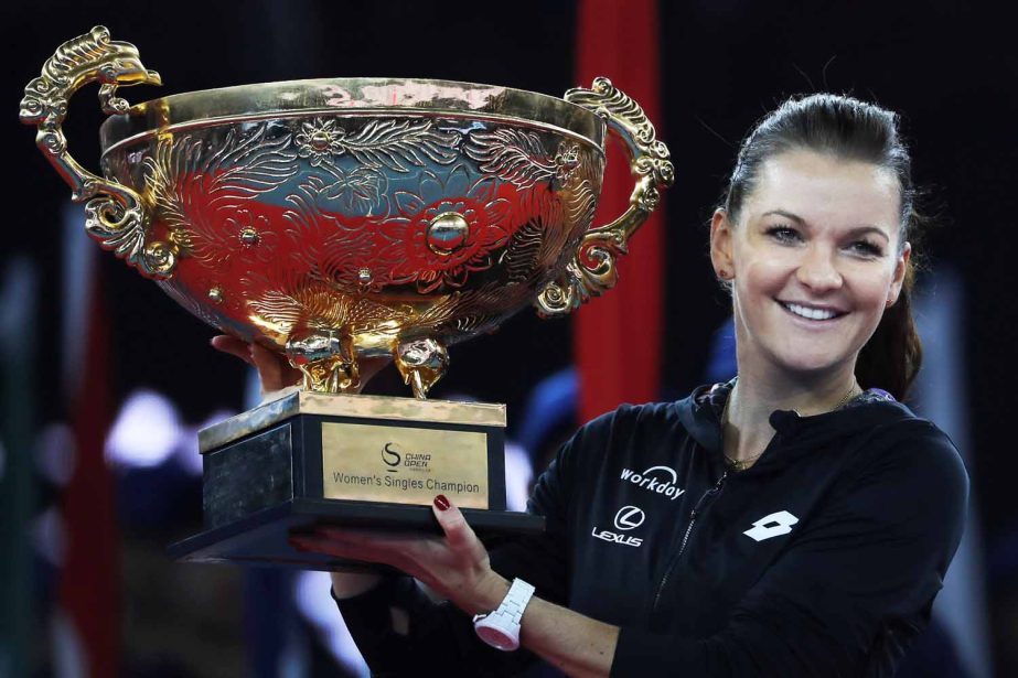 Agnieszka Radwanska of Poland poses with her winner's trophy after defeating Johanna Konta of Britain in the women's singles final match at the China Open tennis tournament in Beijing on Sunday.