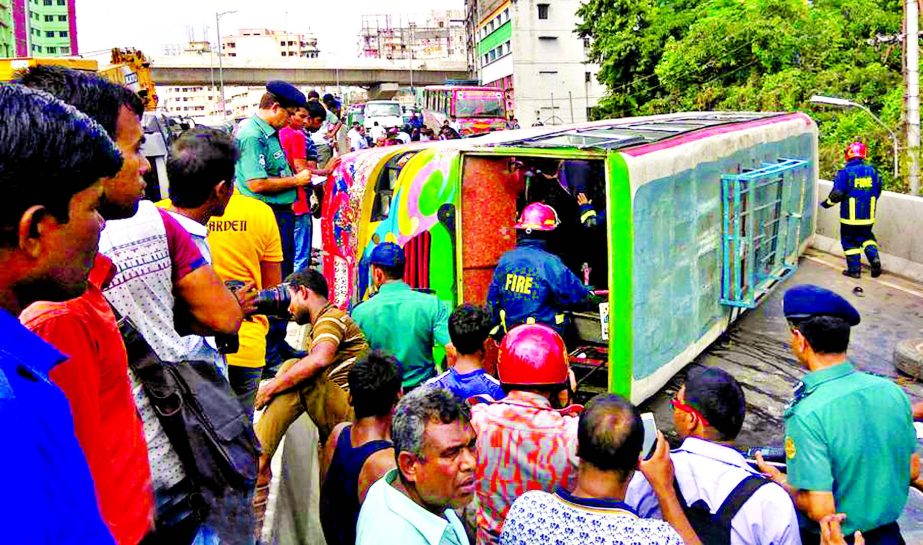 A bus overturned on the Moghbazar flyover in city injuring 12 passengers and disrupted traffic for hours on Sunday.