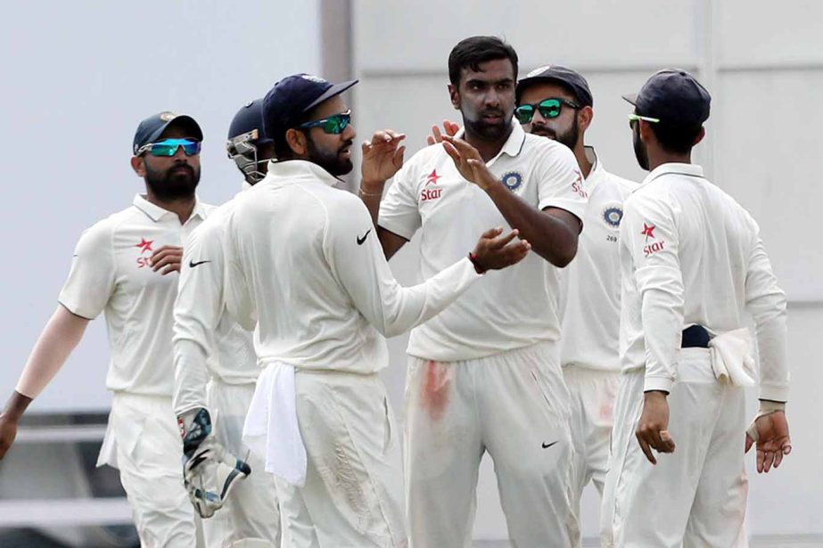 R Ashwin celebrates the wicket of Tom Latham with his team-mates on the 3rd day of 3rd Test between India and New Zealand at Indore on Monday.