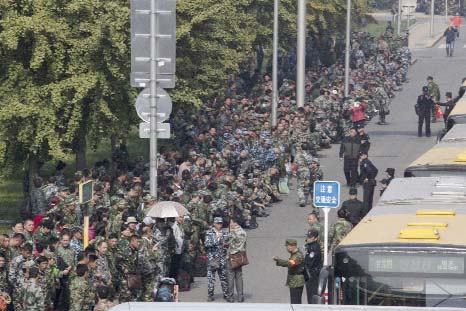 Hundreds of protesters in green fatigues gather outside the Chinese Ministry of National Defense to protest in Beijing, China on Tuesday.