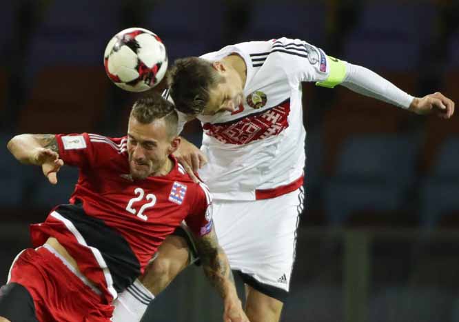 Luxembourg's Aurelien Joachim (left) and Belarus' Aleksandr Martynovich jump for the ball during their World Cup Group A qualifying soccer match between Belarus and Luxembourg at the Borisov-Arena stadium in Borisov, Belarus on Monday.