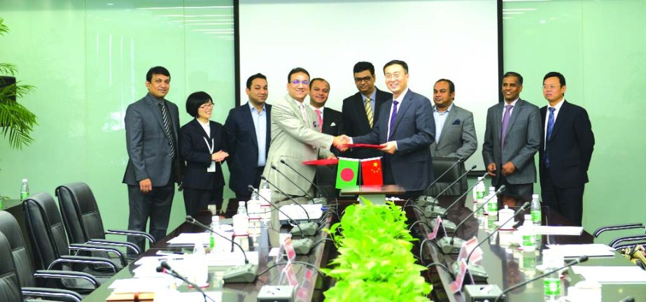 BDC-Magura Group signs MOU with Chinese Company CGGC over strategic cooperation. Picture shows BDC-Magura Group Chairman Mustafa Kamal Mohiuddin and CGGC President Lv Zexiang exchanging MOU documents at a ceremony held at Beijing, China recently.