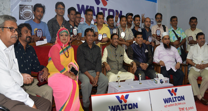 The winners of the Walton Photo Journalists' Sports Festival with the chief guest Minister for Road Transport and Bridges Obaidul Quader, MP and the guests and officials of Bangladesh Photo Journalists' Association pose for photo at the auditorium of Ba