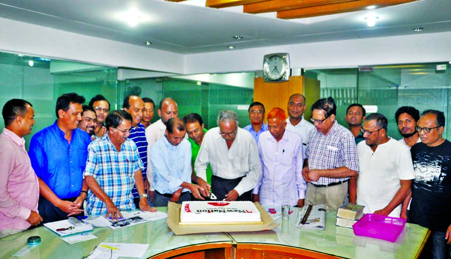 Marking the founding anniversary of The New Nation, A M Mufazzal, Editor of the paper along with journalists and employees cutting a cake at the News Room sent by the telecommunication company Robi to the newspaper yesterday.
