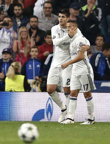 Real Madrid's Alvaro Morata celebrates with Lucas Vazquez scoring his side's 5th goal during a Champions League, Group F soccer match between Real Madrid and Legia Warsaw, at the Santiago Bernabeu stadium in Madrid on Tuesday.