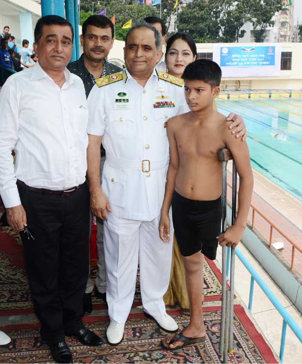 President of Bangladesh Swimming Federation and Chief of Naval Staff Admiral Mohammad Nizamuddin Ahmed (centre front) with the selected disabled talented juvenile swimmer Pallab Kumar Karmakar pose for photo at the Syed Nazrul Islam National Swimming Comp