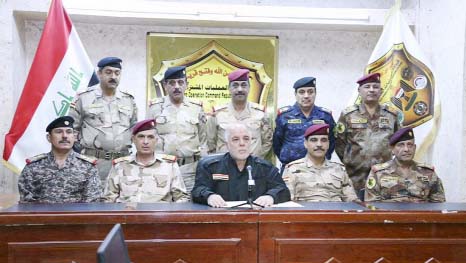 This photo released on his official Facebook page shows Iraqi Prime Minister Haider al-Abadi, center, surrounded by top military and police officers as he announces the start of the operation to liberate the northern city of Mosul from Islamic State milit