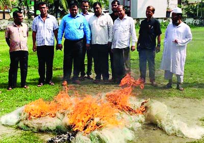 BETAGI(Barguna):Mahmudur Rahman, UNO, Betagi Upazila burning current nets seized from Bishkhali River yesterday.