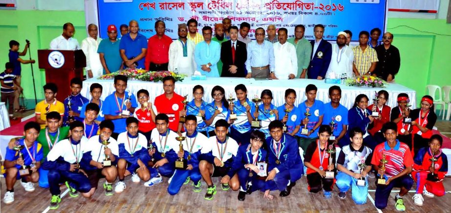 The winners of the Sheikh Russel Table Tennis Championship with the guests and officials of Bangladesh Table Tennis Federation pose for a photo session at the Shaheed Tajuddin Ahmed Wooden Floor Gymnasium on Friday.