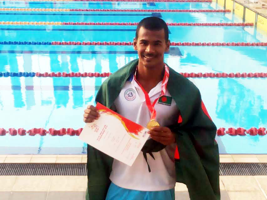 Ariful Islam of Bangladesh pose with his trophy and certificate after earning second gold medal in the 50 metre breaststroke of the South Asian Aquatic Championship in Sri Lanka on Friday. Earlier, Ariful Islam gained his first gold medal in 100 metre bre